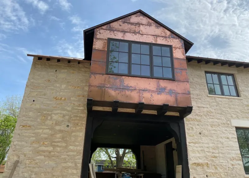 Copper metal panel facade on a stone building for Metal Roof Coating in Salinas